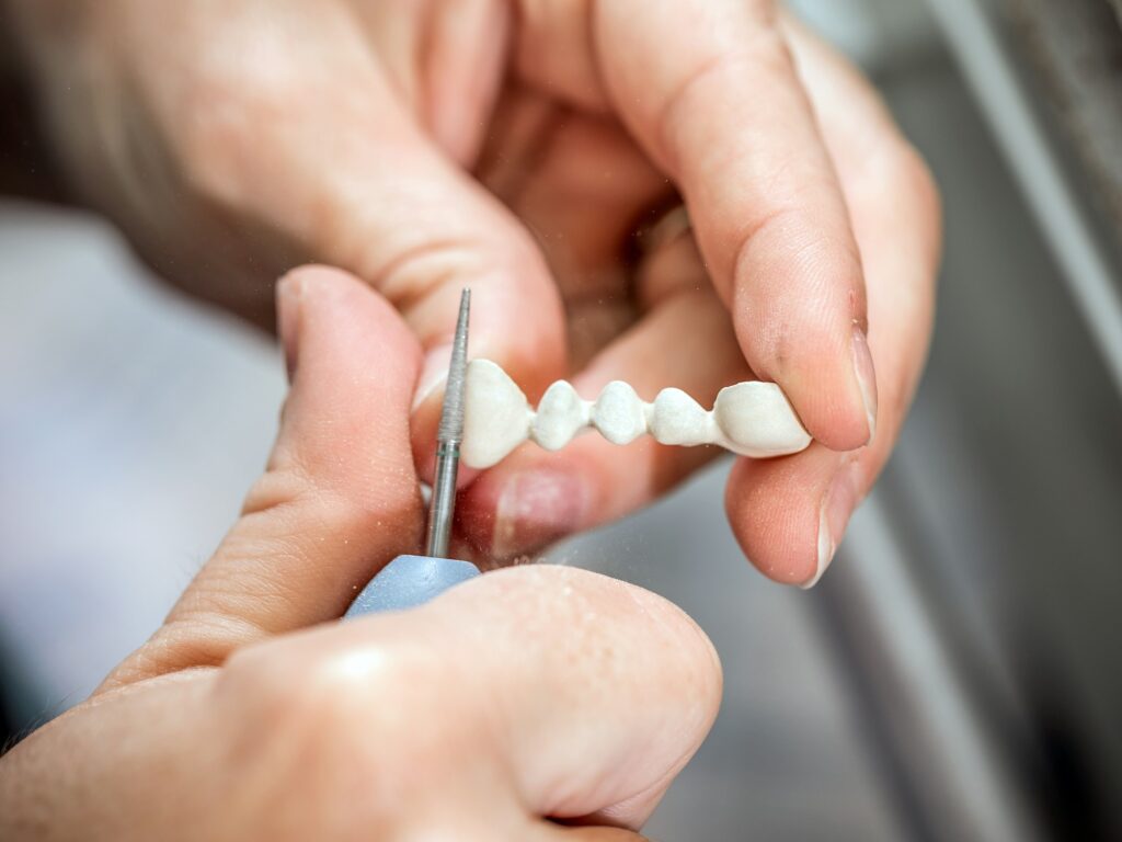 Dental technician molding teeth